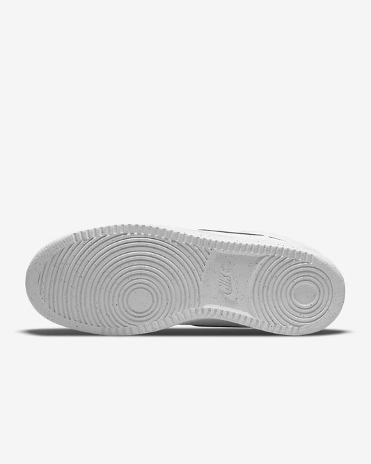 Sole view of white Nike Court Vision Mid NN sneaker showing circular tread pattern on light gray background