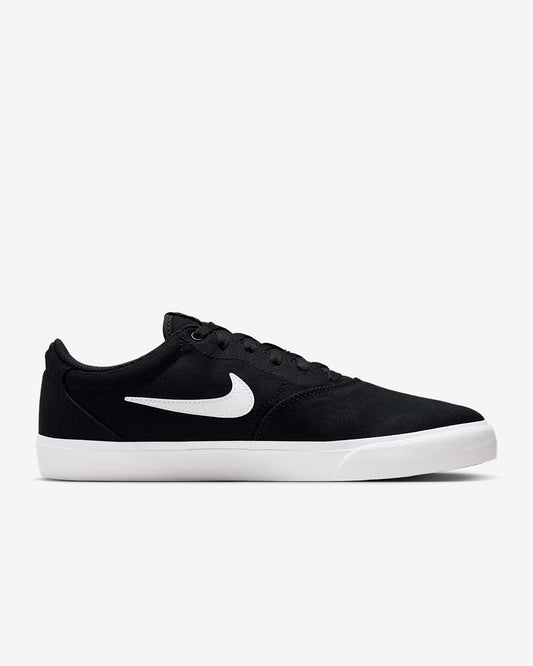 Side view of black Nike SB Charge Canvas sneaker with white swoosh logo and white midsole on white background