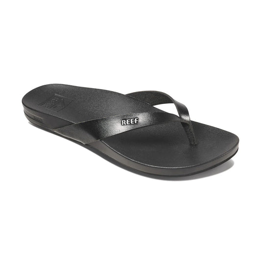 Side view of black Reef Cushion Court sandal with REEF branding on white background