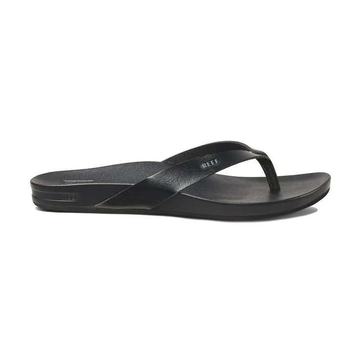Side view of black Reef Cushion Court sandal with arch support and logo on white background