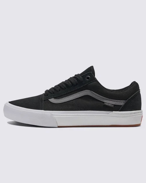 Side view of black BMX Old Skool skate shoe with grey stripe and white sole on white background