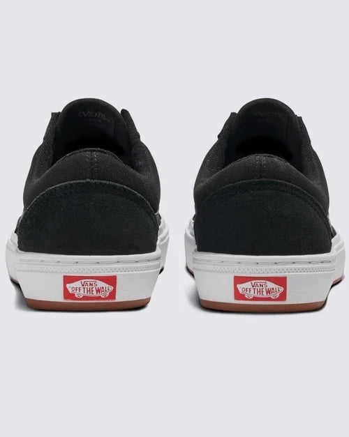 Rear view of black BMX Old Skool skate shoes with red and white heel logo and white soles on white background